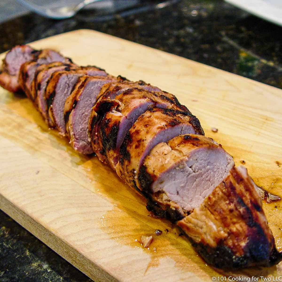 sliced pork tenderloin on wood