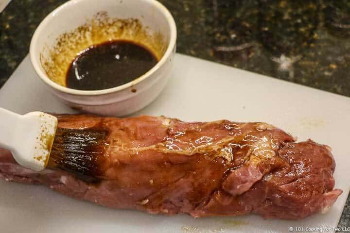 brushing pork tenderloin with sauce