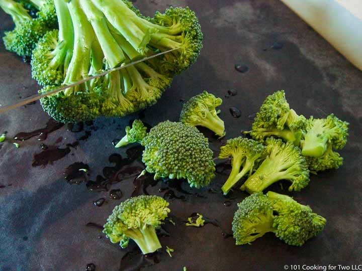 trimming broccoli into bite size pieces