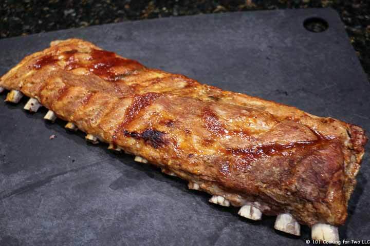 browned baby back ribs on black board