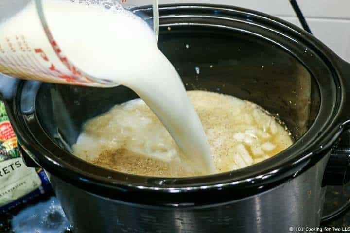 adding milk to crock pot.