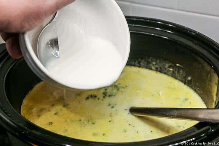 adding slurry to crock pot.