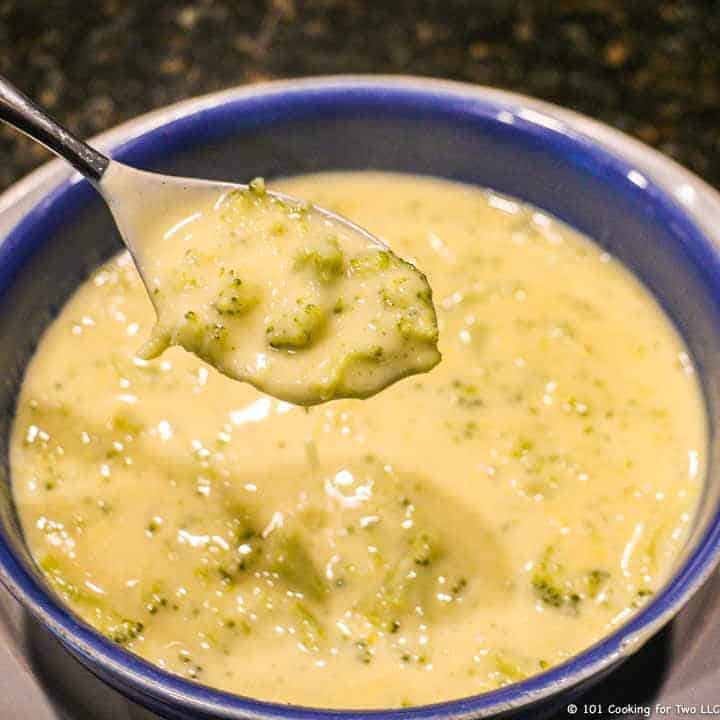 Broccoli cheese soup in a spoon.
