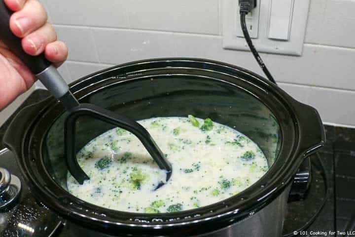 using a potato masher in the crock pot,