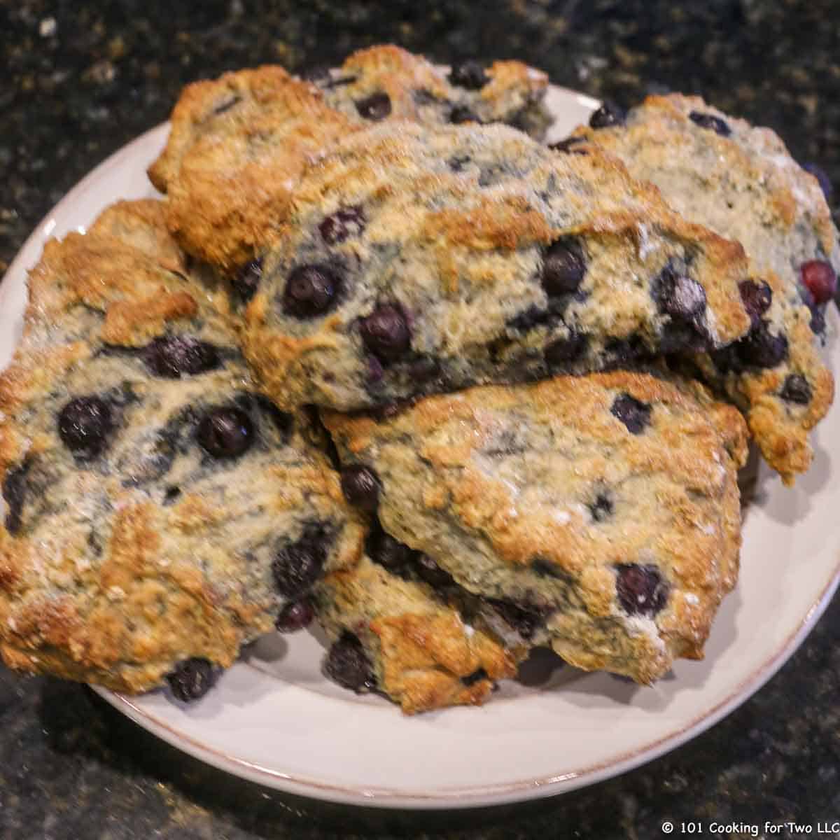 Plate full of blueberry scones,