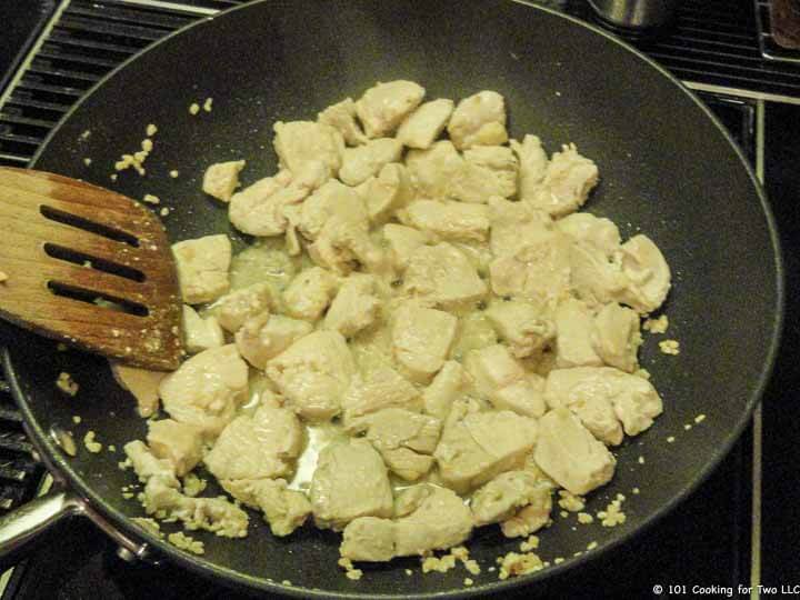 cooking chicken in black pan