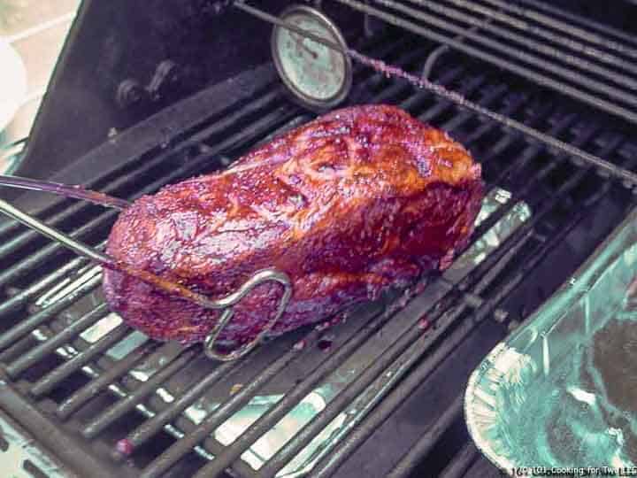 placing pork butt on grill