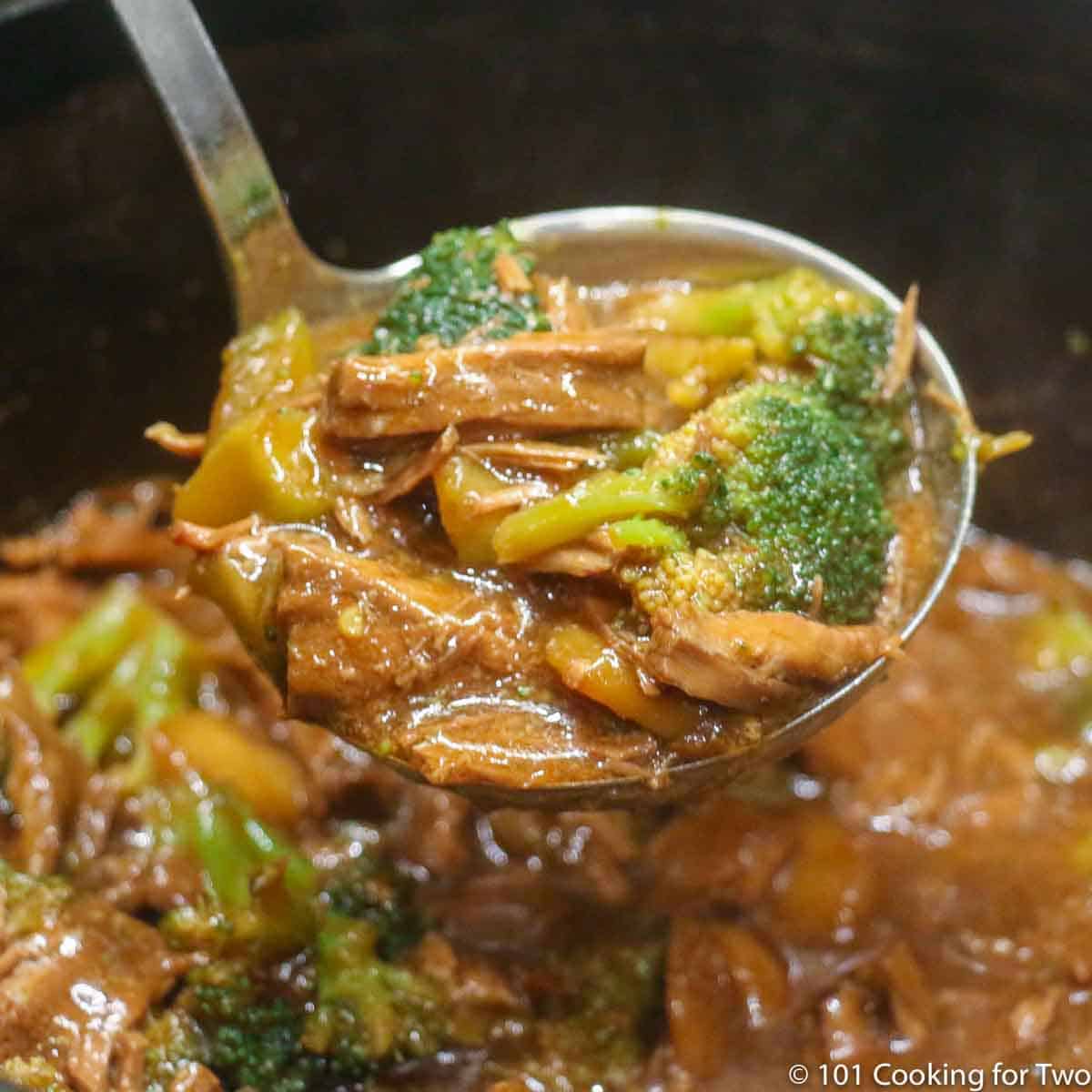 beef and broccoli in ladle.