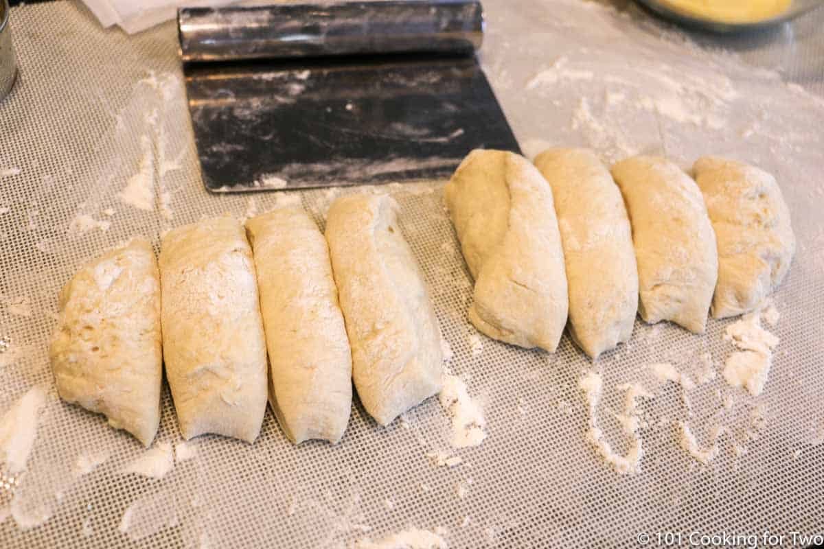 cutting dough into eight equal parts on parchment