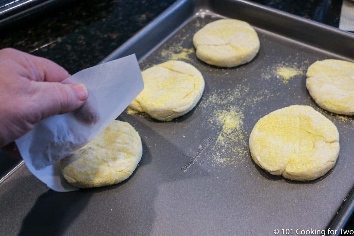 flipping raw muffins onto baking tray