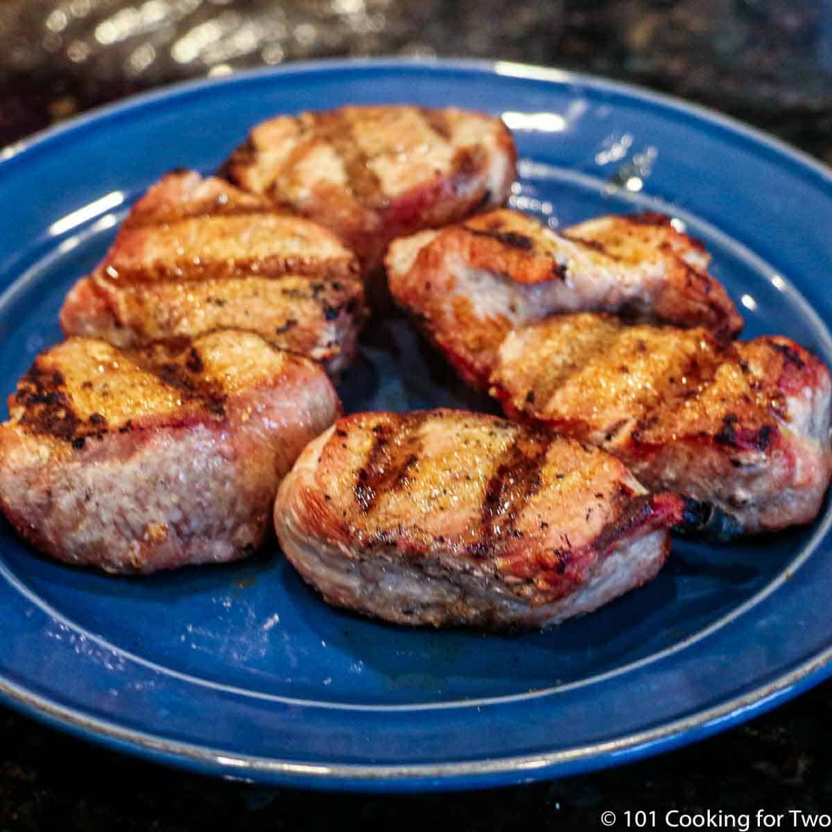 grilled medalions on blue plate.