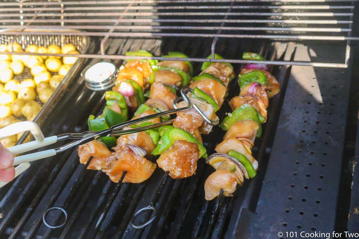 kabobs on grill surface.