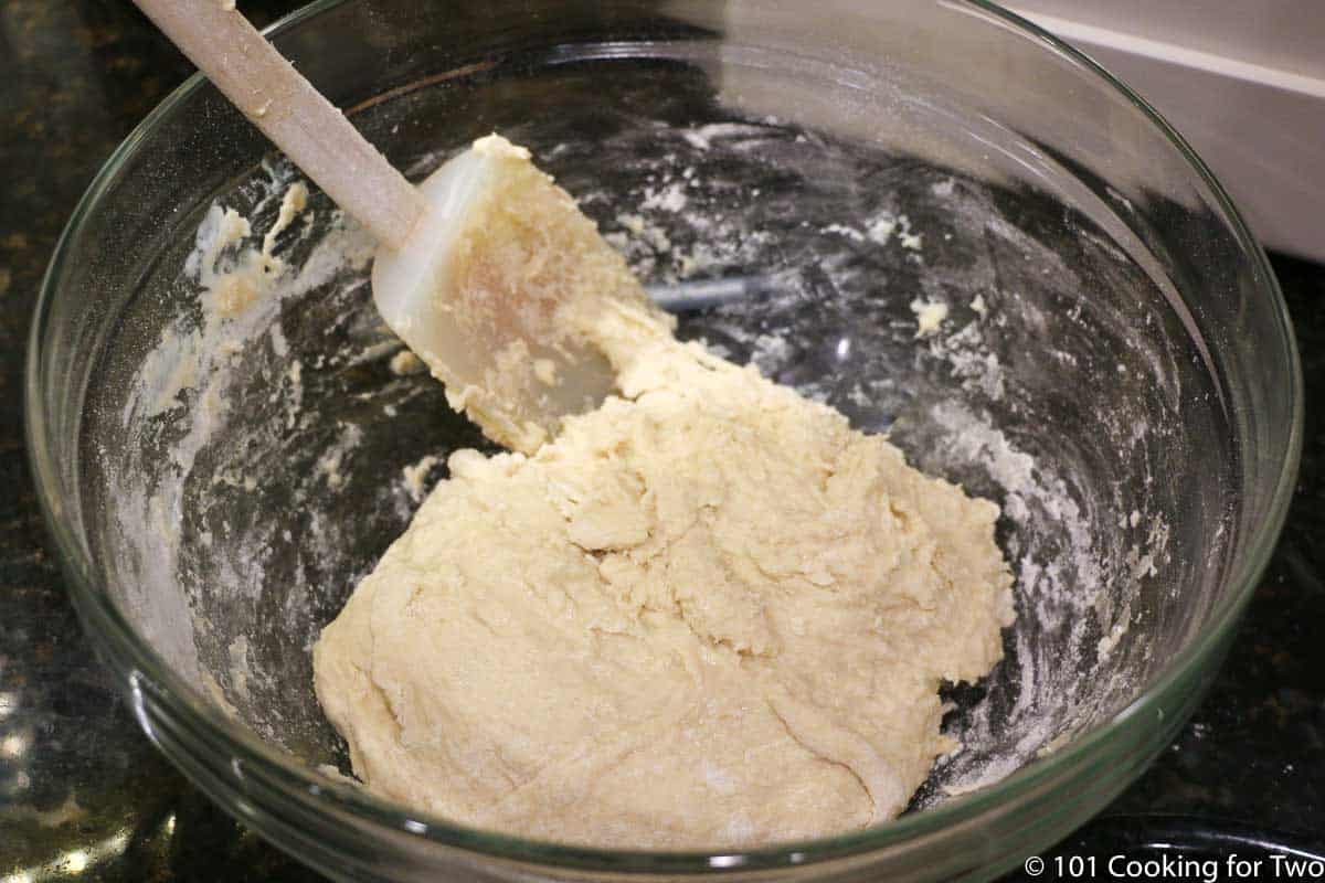 mixing dough in bowl with spatula