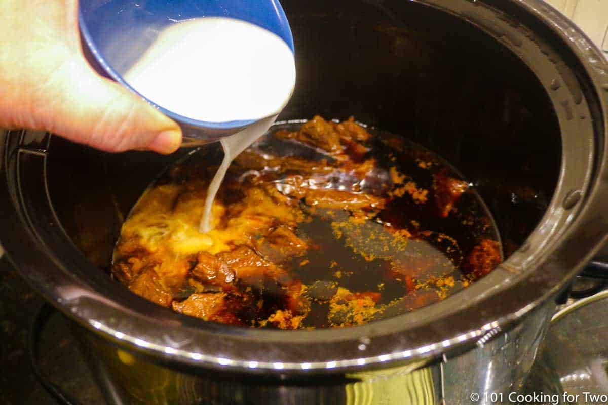 pouring cornstarch slurry into crock pot.
