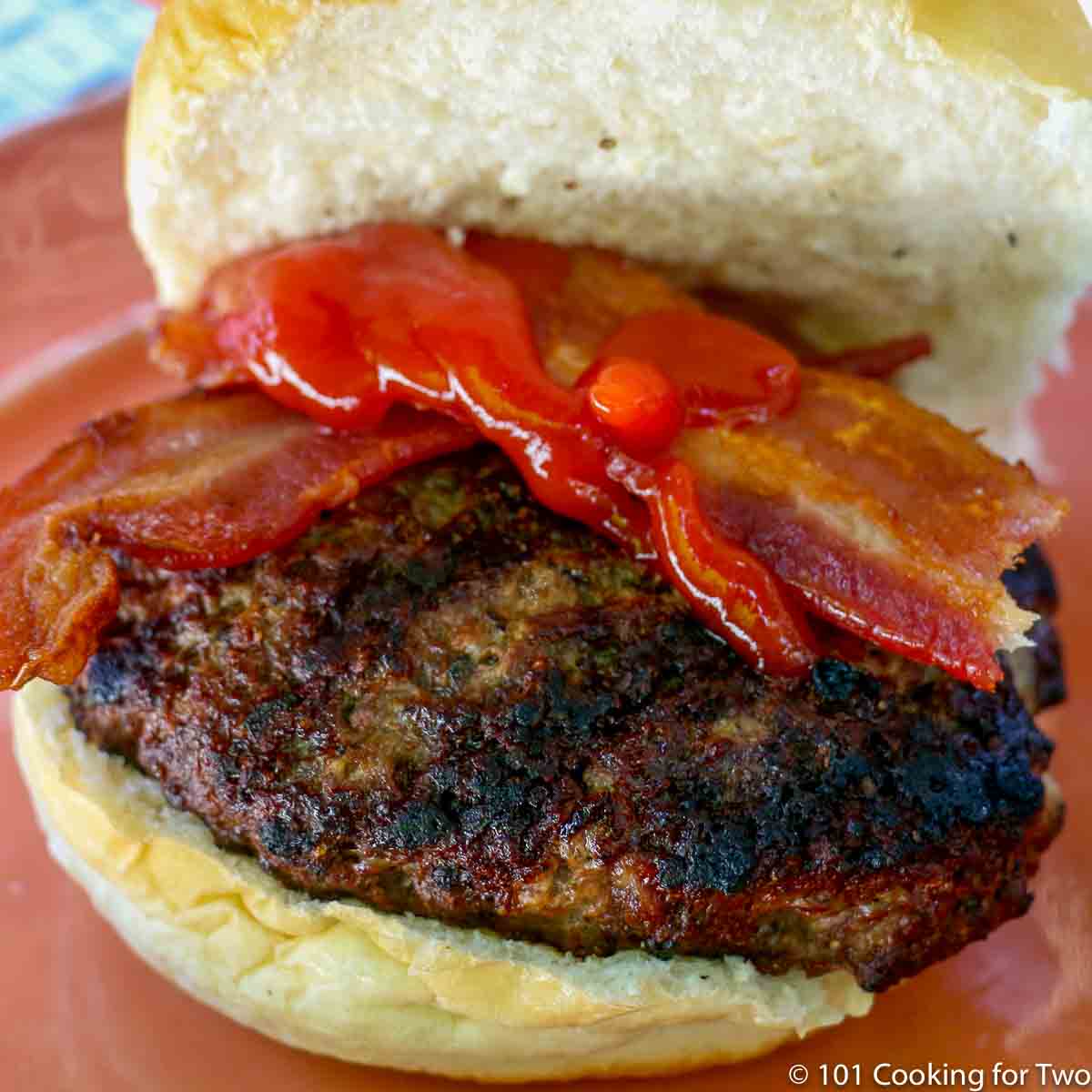 burger on a bun with bacon