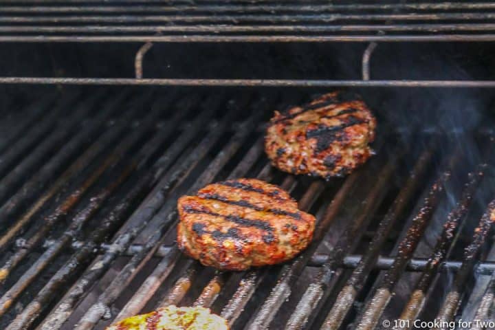 cooked burgers on grill grate