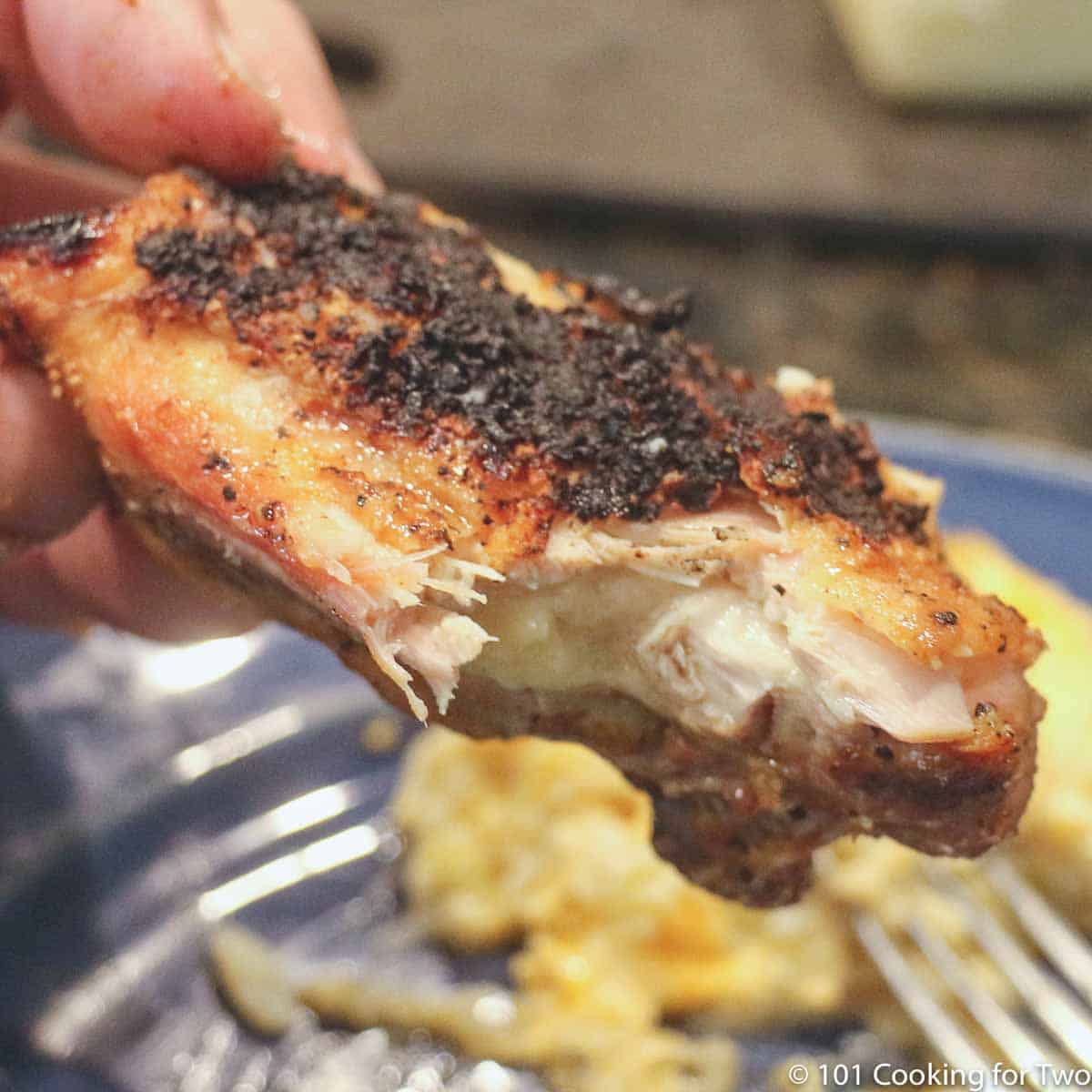 cooked chicken thigh with bite out of it