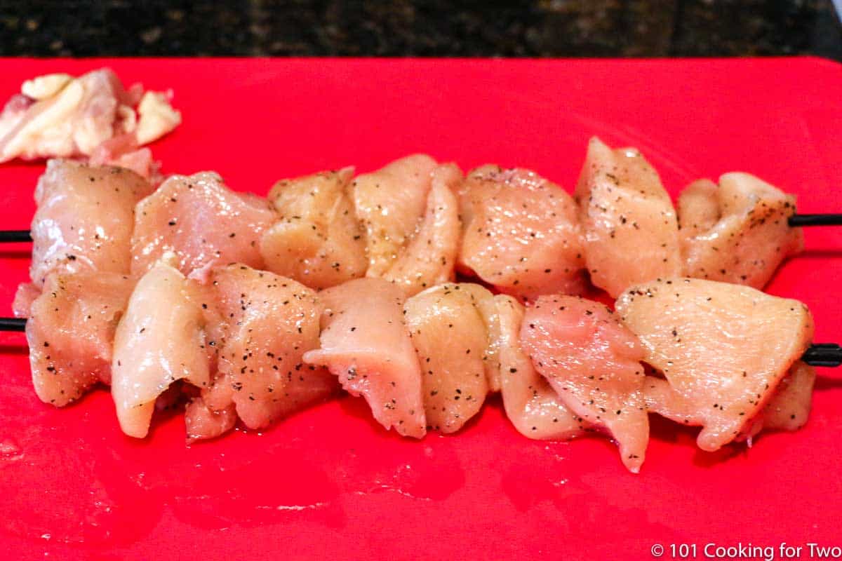 cubes of chicken on skewers.