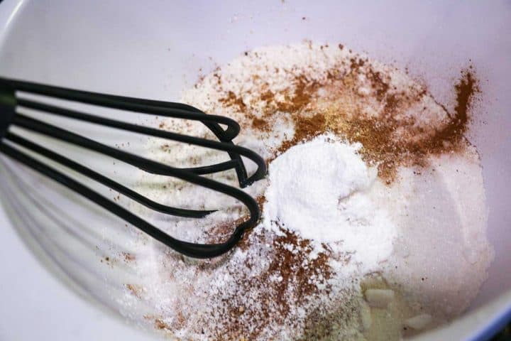 dry ingredients with whisk in white bowl