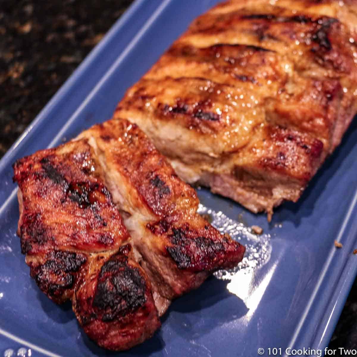 grilled boneless ribs on blue plate cut