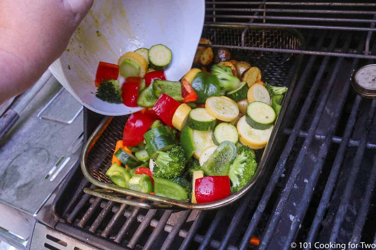 pouring vegetables into grill pan.