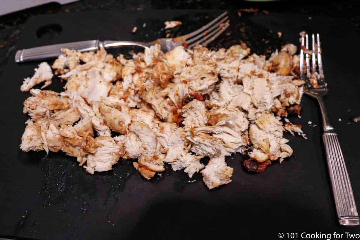 shredded chicken on a black board