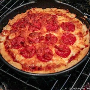 whole cook pizza in pan on rack