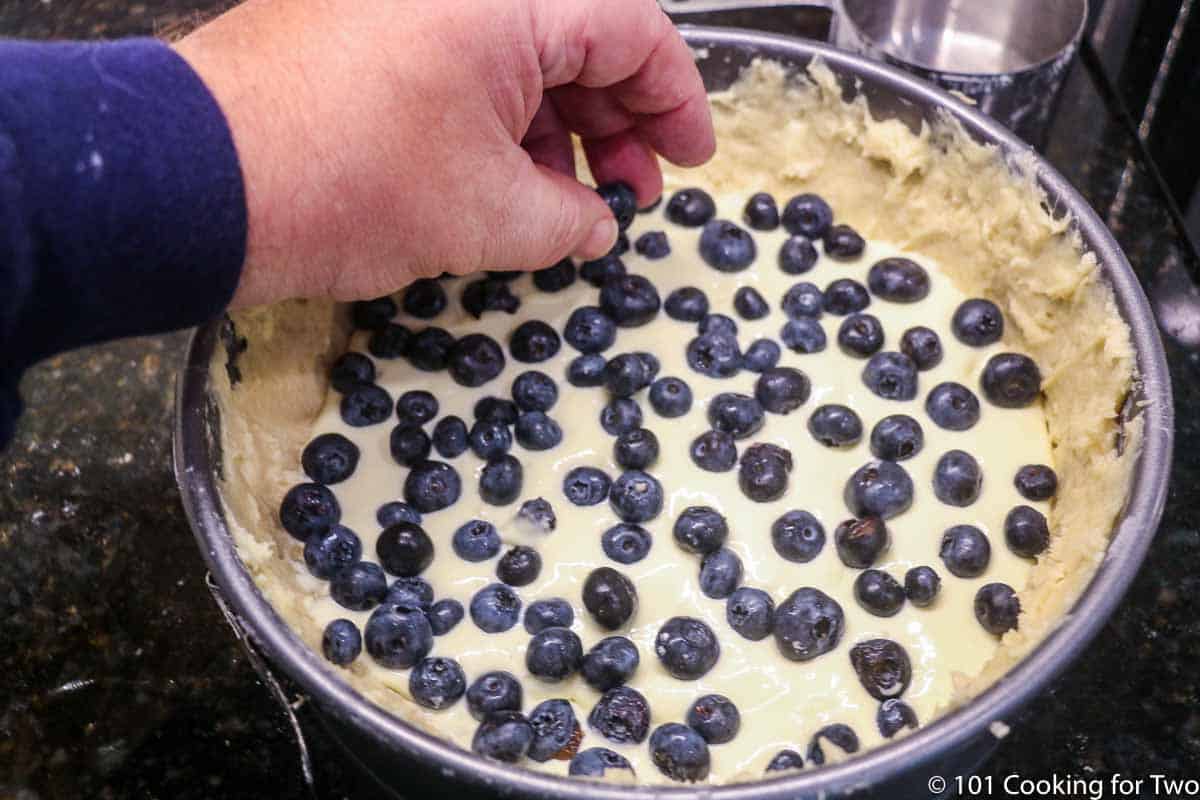 adding blueberries to top of filling.