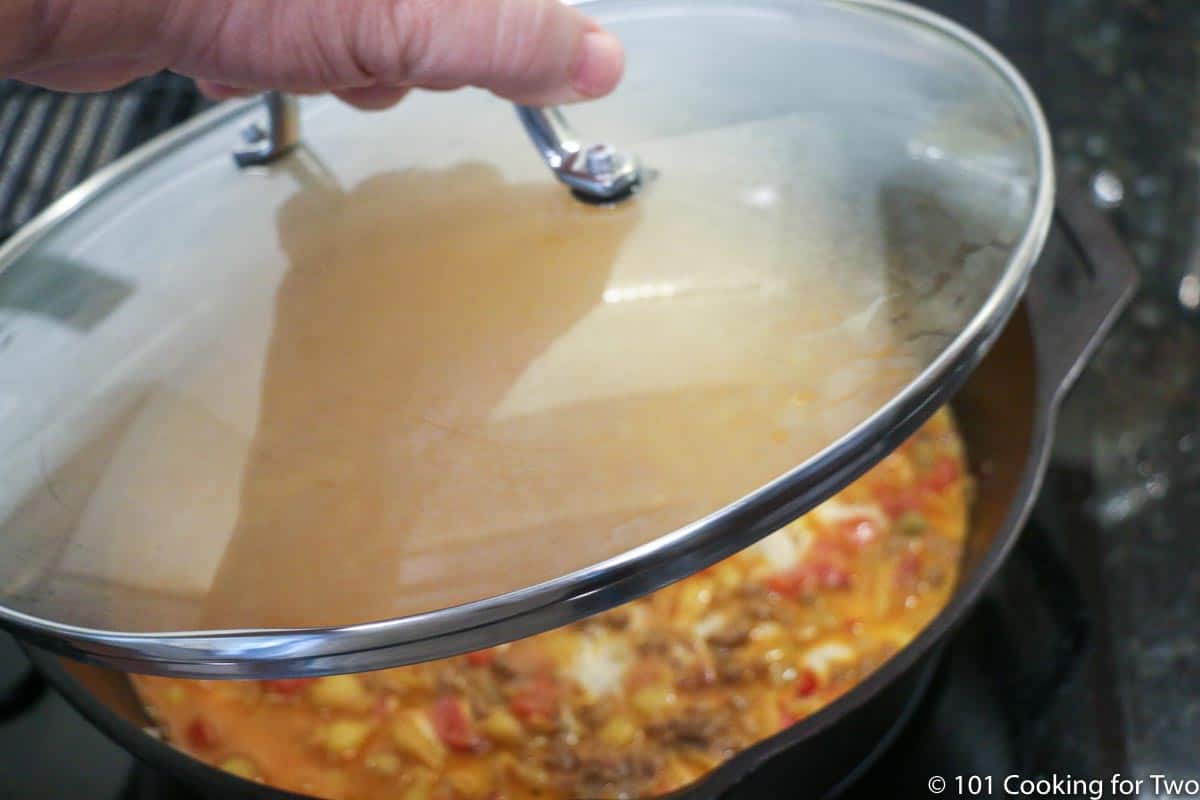 covering the pan with a glass lid