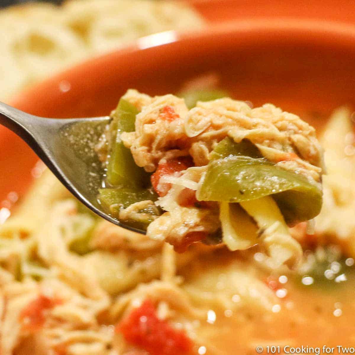 parmesan chicken soup with pasta on spoon