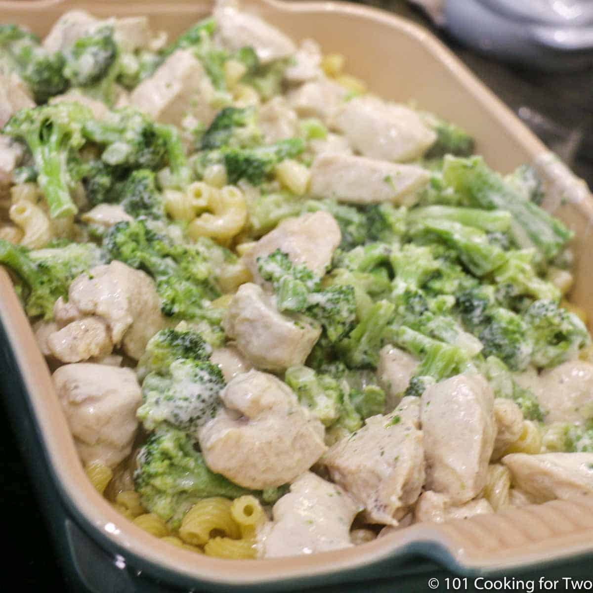 pour sauce with chicken and brocolli over pasta.