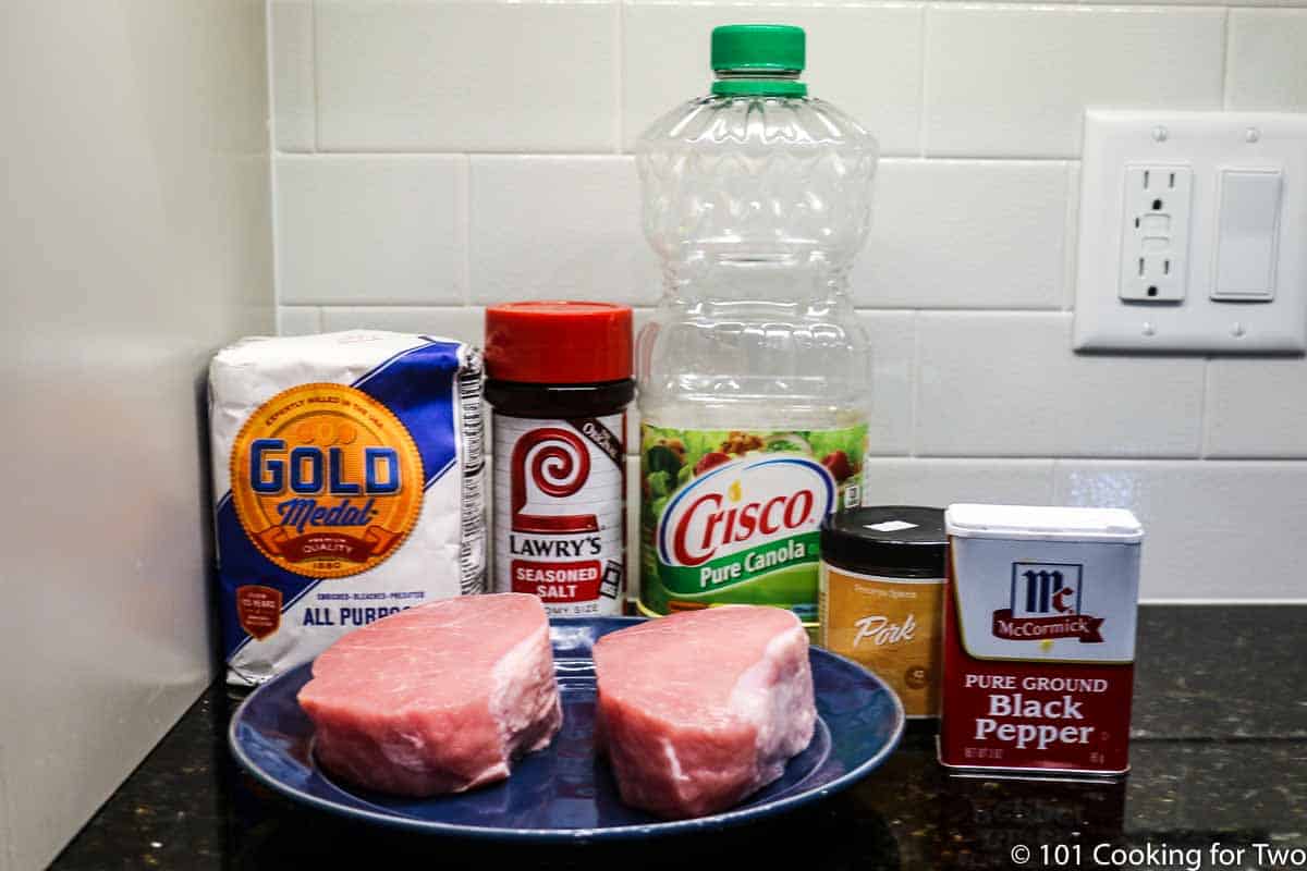 thick pork chops on plate with seasonings