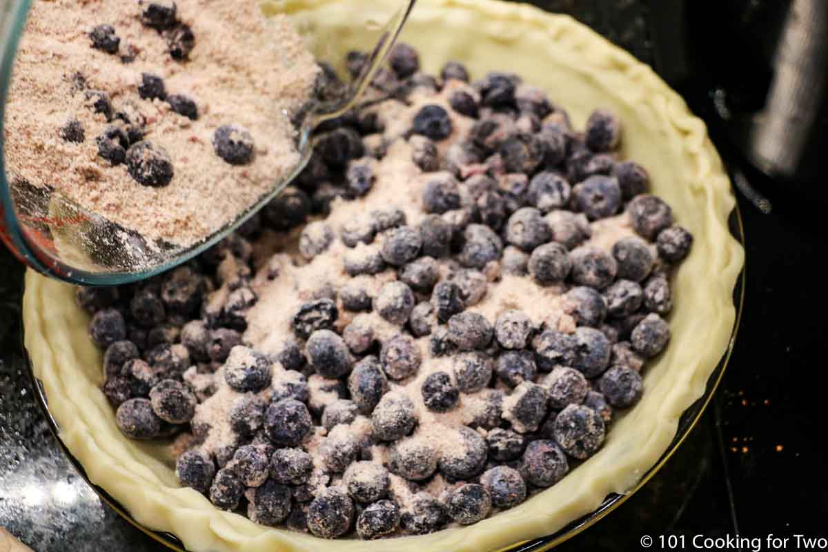 adding blueberry filling to crust