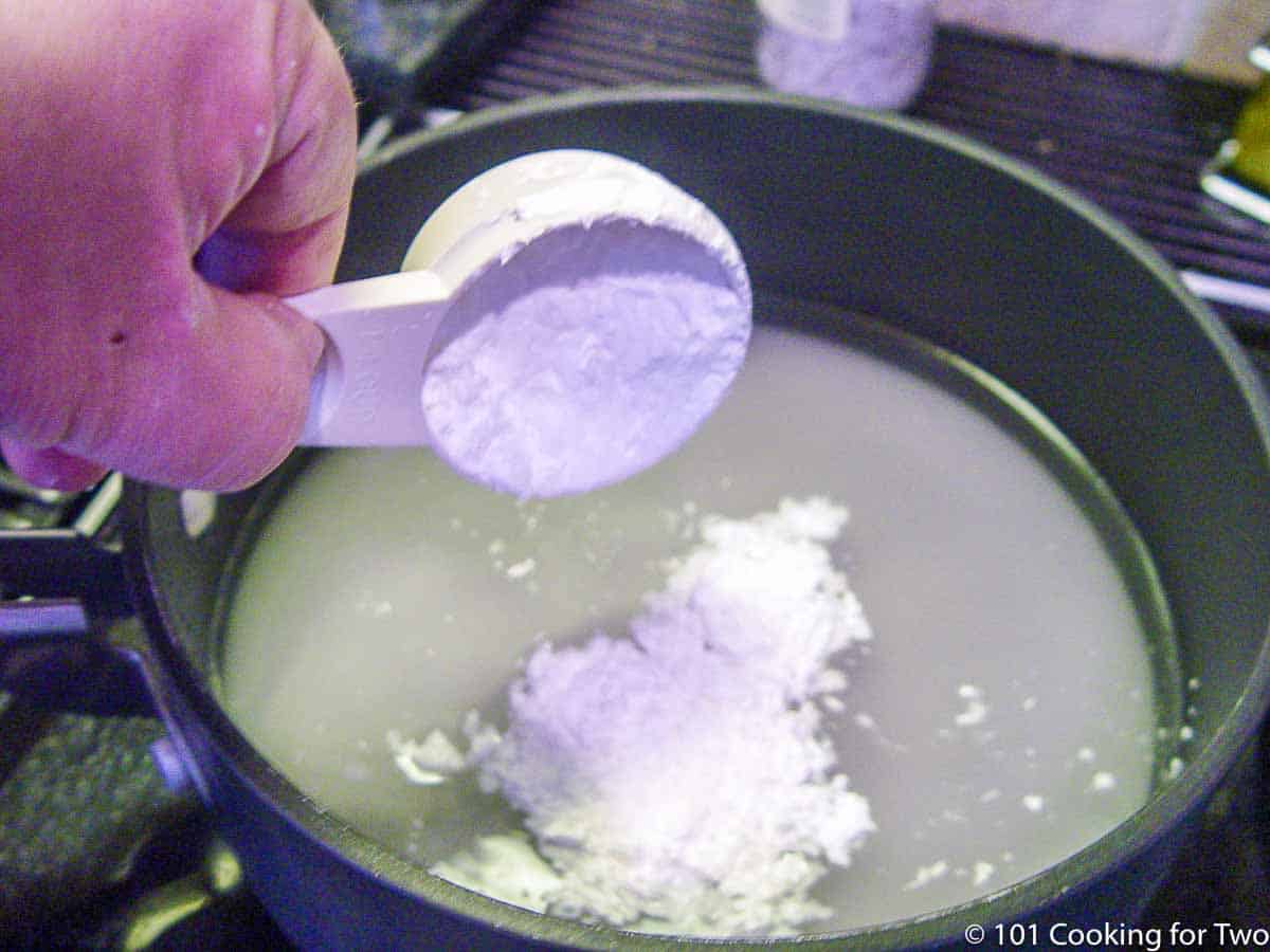 adding cornstarch to sugar in sauce pan