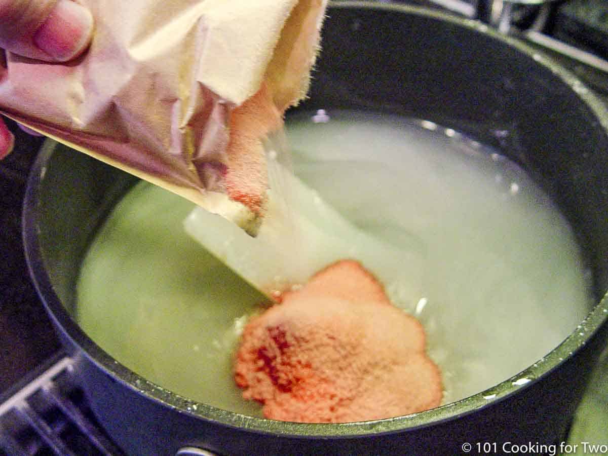 adding jello into sugar in sauce pan