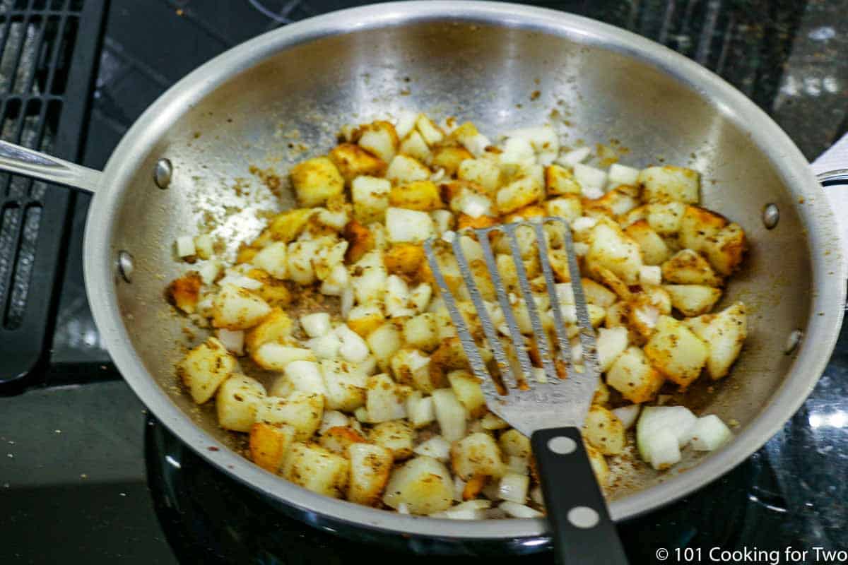 .browning potatoes in pan.