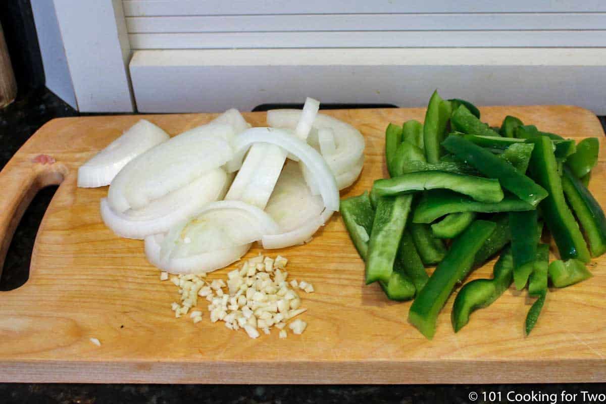 chopped onion and pepper on wooden board