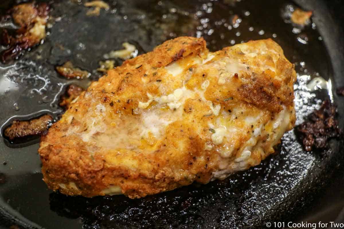 cooked chicken in cast iron pan