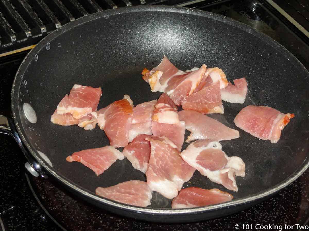 cut up bacon in a frying pan