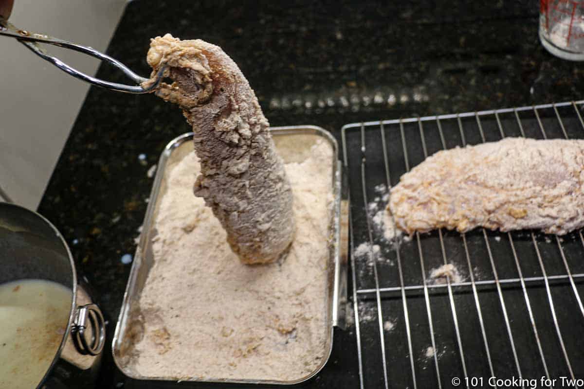 dipping chicken into the coating and place on rack.