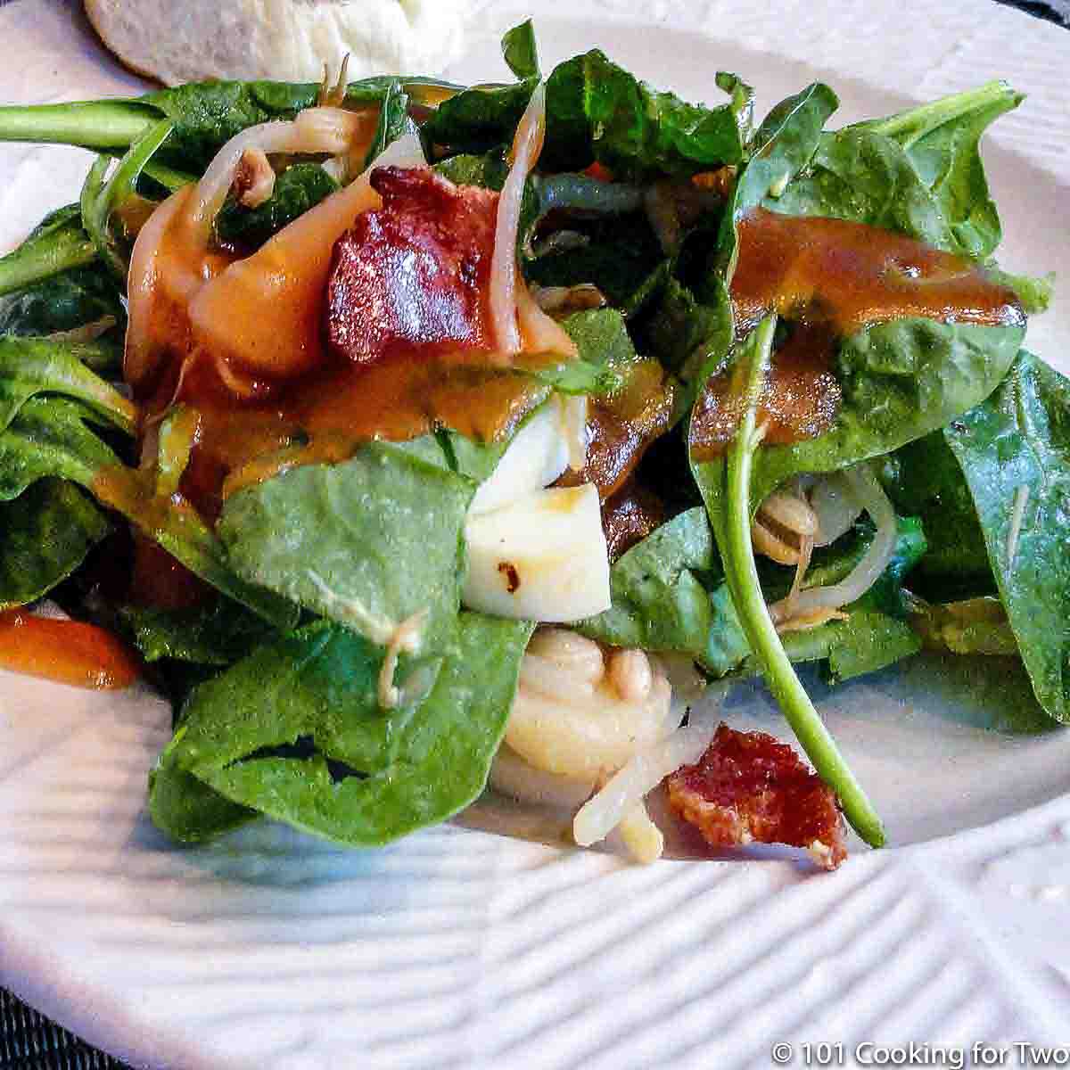 fresh spinach salad on white plate