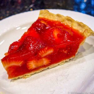 fresh trawberry pie slice on white plate