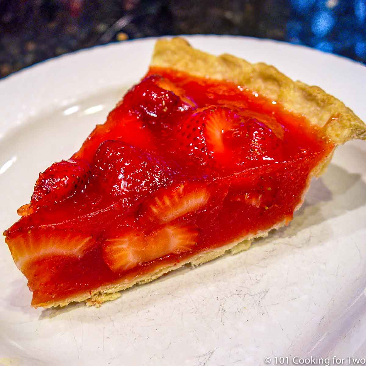 fresh trawberry pie slice on white plate