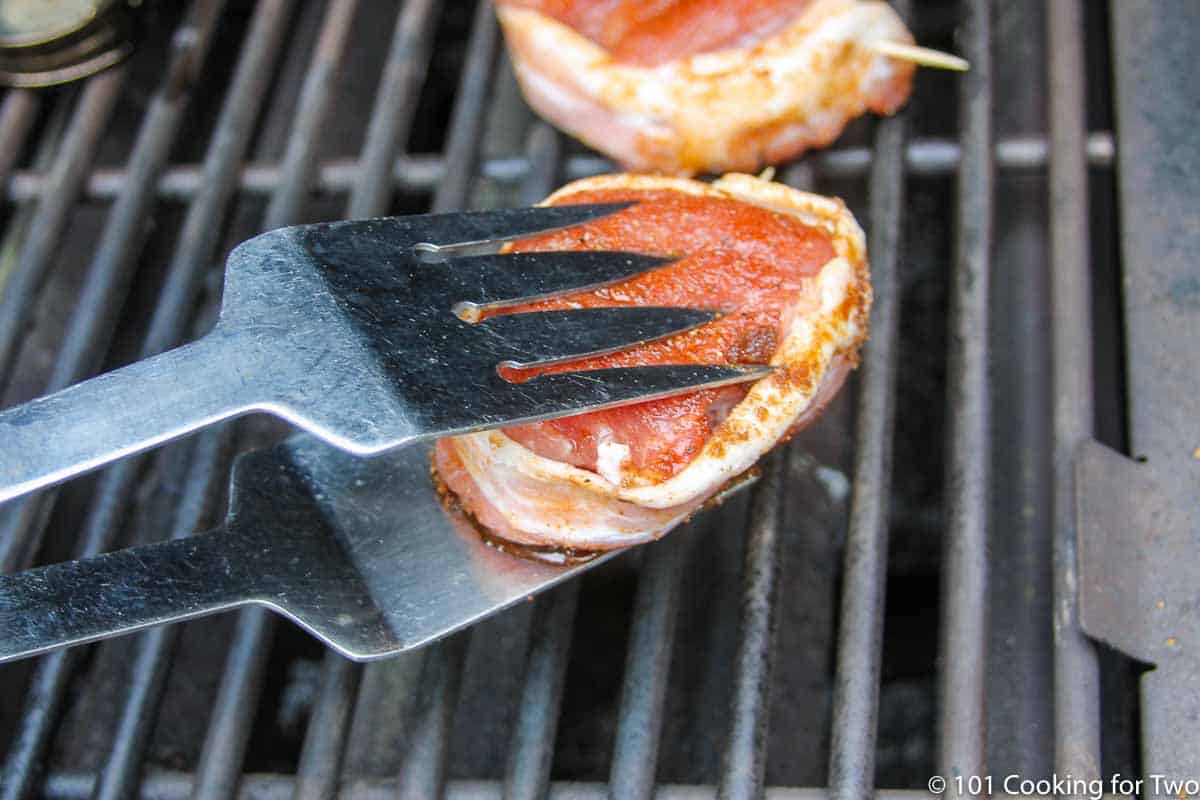 placing pork medalions on grill