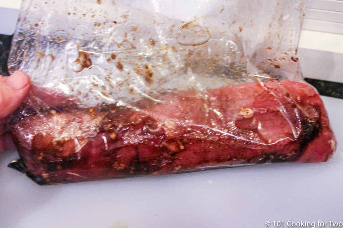 Pork tenderloin in bag with marinade.