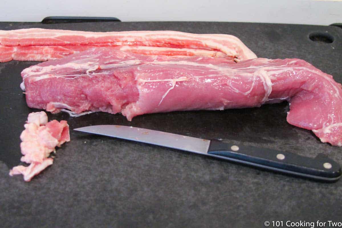 pork tenderloin trimmed on black board