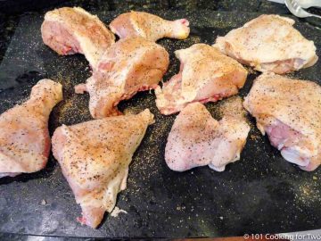 raw chicken seasoned with on black board