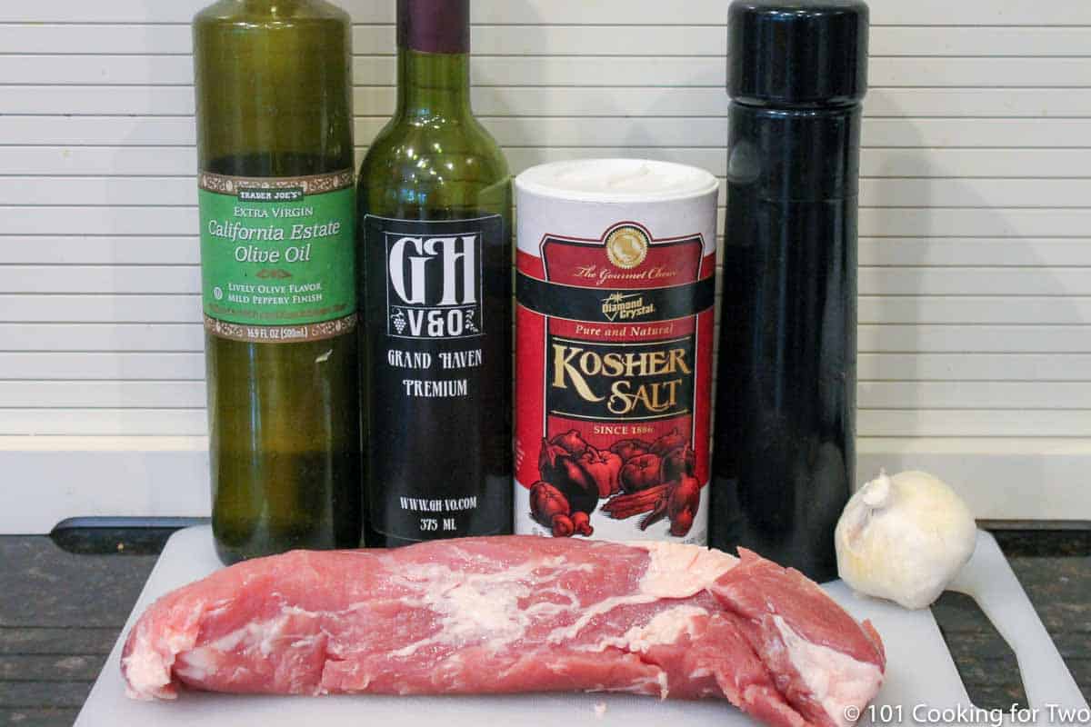Raw pork tenderloin with other ingredients.