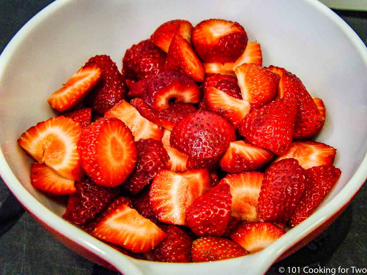 trimmed strawberries in white bowl