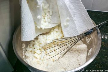 adding dried apple bits to the dry mixture
